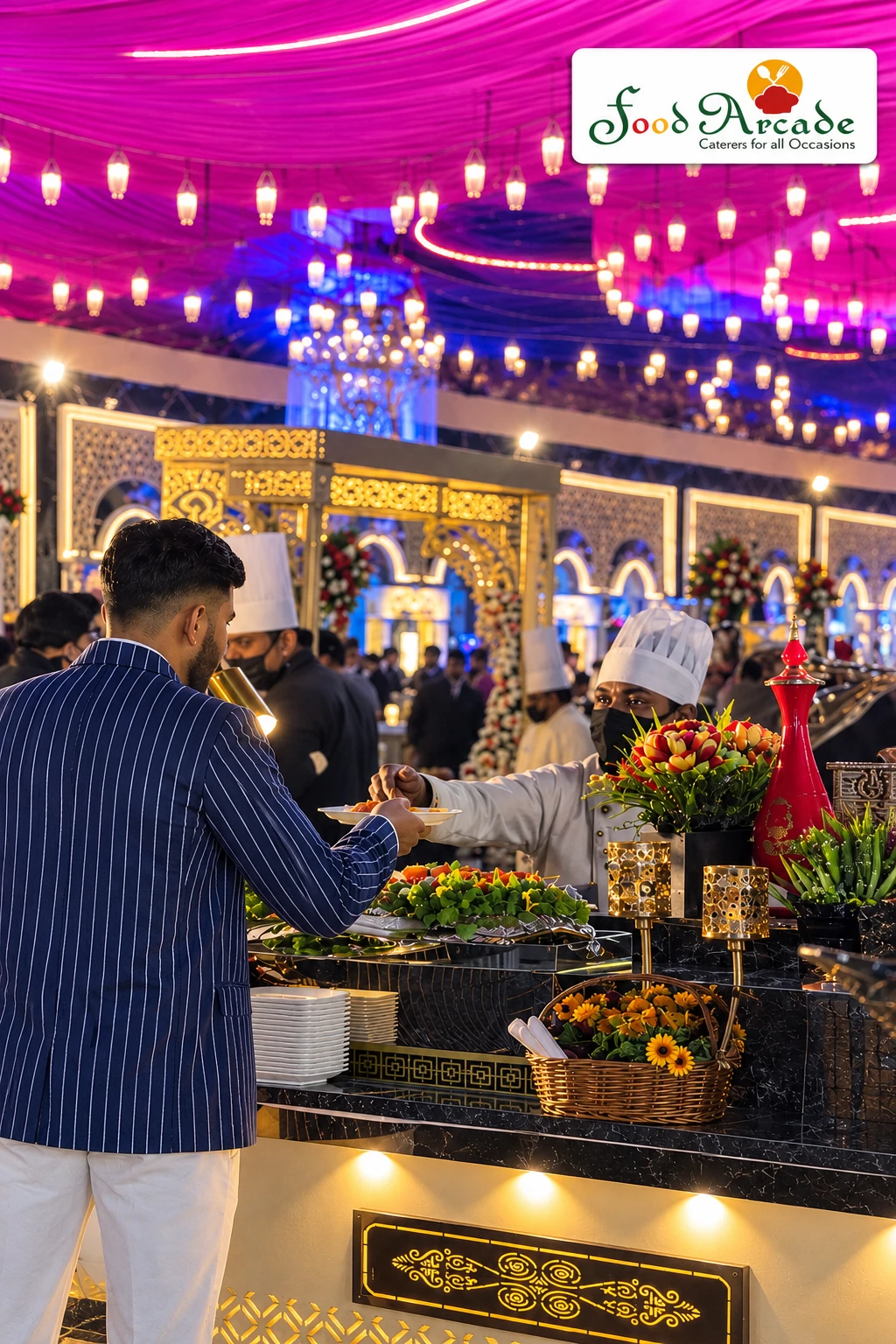 Buffet counter with flowers and gold detailing beneath a pink canopy hung with lanterns